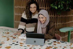 Two women using a laptop