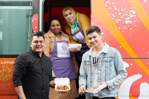 Staff and clients posing in front of Fare Go Foodtruck
