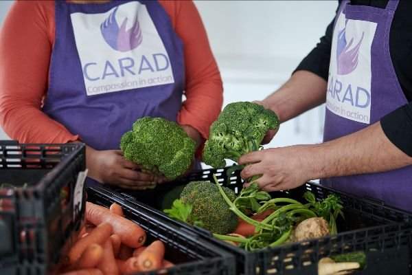 Two people arranging the food donations