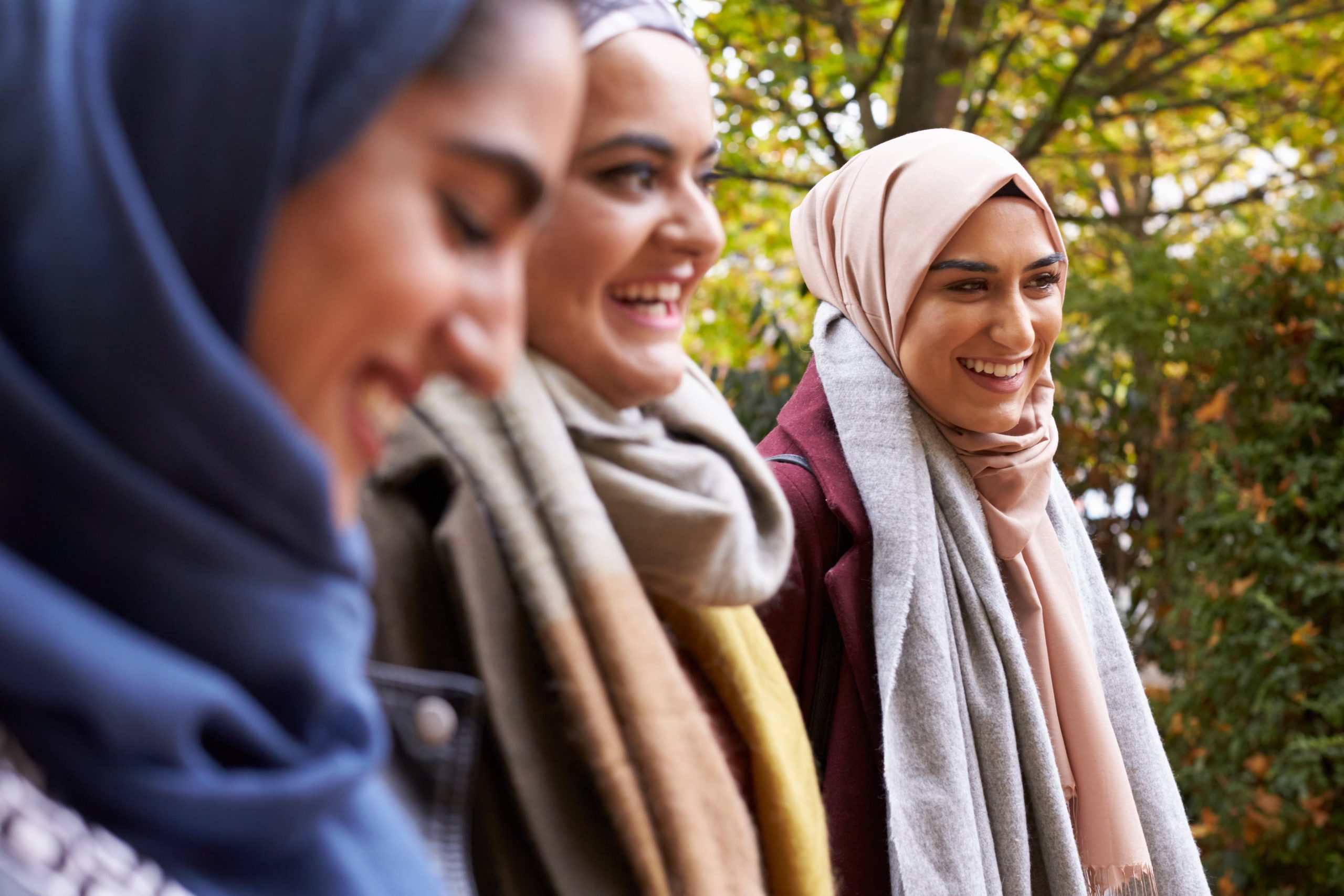 Three young woman wearing hijab walking on park