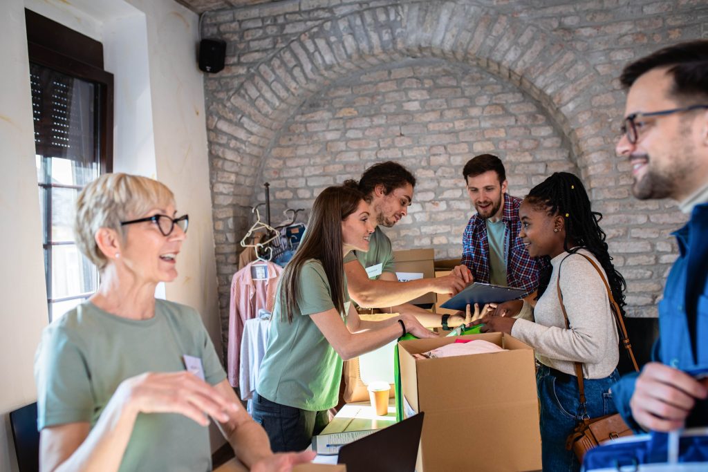 Volunteers working in a stall while clients browse through items