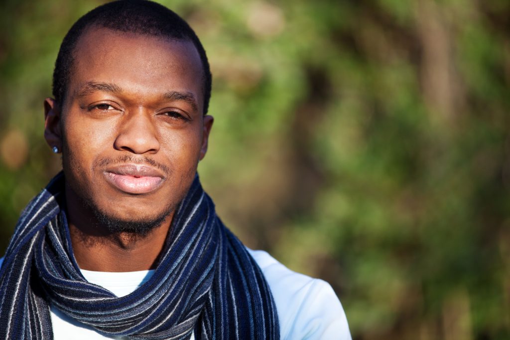 Dark skin men faces the camera