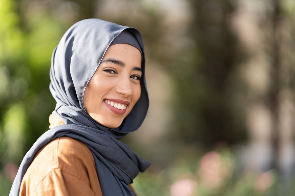 White women wearing hijab smiles to the camera